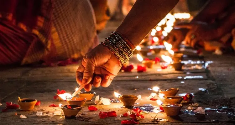 Diyas or small clay oil lamps are lit in houses and temples across the country.